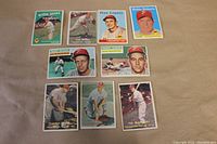 Nine Philadelphia Phillies baseball cards arranged on a beige surface. Cards show players in various poses and uniform details from the late 1950s.