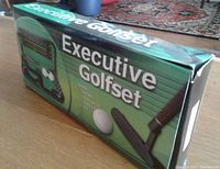 Top view of the Executive Golf Set original box with graphic and textual description of set contents.