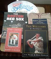 Five baseball books displayed on a surface: The Baseball Anthology, Ted Williams: A Tribute, The Boston Red Sox, Take Me Out to the Ballpark, and The Grind.