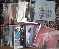 Photos of 28 rock LP albums spread out showing original album covers with varied rock artists from the 1970s and early 1980s.