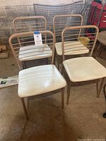 Set of four vintage folding chairs showing front and top views of padded vinyl seats and metal frames.