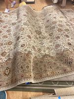 Folded rug showcasing overall floral pattern and pile condition