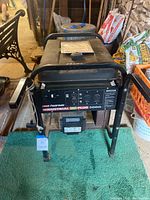 Front view of Coleman Powermate Industrial Plus 5000 generator showing overall frame, handles, fuel tank and engine