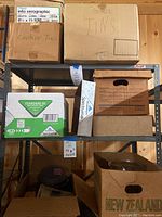 Six boxes on shelves; two boxes labeled 'Cookie Tins' and various other storage boxes