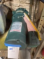 Green Myers well jet pump motor with attached black component, showing front and side views.