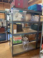 Metal shelving unit with five tiers, shown with various storage boxes and items on shelves, but the shelving contents are not included in the lot.
