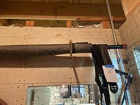Side view of the cargo unloader showing tubular mesh section and metal frame with crank handle.