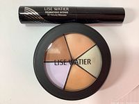 Photo showing the Lise Watier Dramatique Intense mascara tube and the correctors palette with five shades labeled Lise Watier.