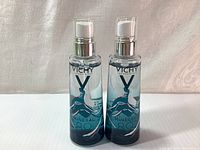 Photo showing two full bottles of Vichy Mineral 89 serum with pump dispensers.