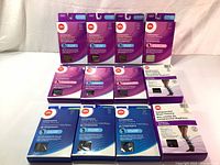 Lot of twelve boxed compression hosiery and dress socks including purple and blue colored boxes showing different compression sheer hosiery and dress socks for men and women.
