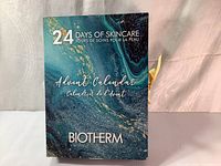 Front view of the closed Biotherm 24 Days of Skincare Advent Calendar box with marble design and branding