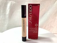 Photo of the Shiseido Sheer Eye Zone Corrector product bottle and its red box packaging showing the brand, product name, volume, and shade 101 Very Light.