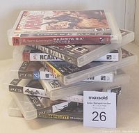 Stack of 9 PS3 game cases showing various titles.