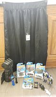 Black Batman gauntlet, Hot Wheels packaged cars, assorted Batman mini figures, and black skirt in the background.