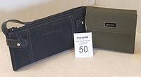 Black Kenneth Cole mini handbag and olive green St Johns Bay wallet placed side by side on a flat surface with a MaxSold lot number card.