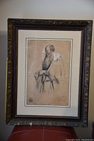 Full view of framed pencil drawing portrait of a bearded man.