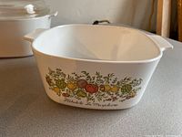 Square ceramic casserole dish featuring vintage vegetable design and French text on the side.