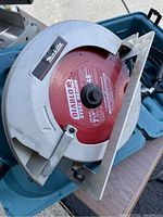 Close up of Makita skill saw blade and casing showing Diablo steel demolition blade in good condition inside hard plastic carrying case.