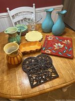 Entire collection of Southern Living ceramic and cast iron kitchen pieces displayed on table.