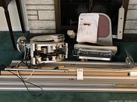Full view of Acorn chair lift components including seat, motor unit, track, and instruction booklet.