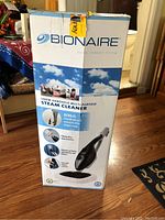 Photo of Bionaire 1300 watt handheld multi-purpose steam cleaner box featuring product image and branding.