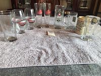 Overview of all nine glasses and mugs on a white towel