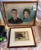 Two framed art prints: a vintage couple portrait and Ken Danby serigraph 'The Skates' print, arranged on a cloth surface
