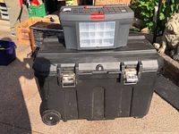 Large black Stanley ProMobile Job Chest toolbox with wheels, metal latches, lock and keys, stacked underneath smaller Zag toolbox