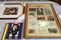 Three items on a cloth surface: framed WWII political leaders print, framed Lenin poster, and Che Guevara plaque. A measuring tape shows plaque approx. 7 inches tall.