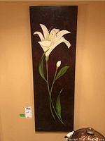 Front view of vertical canvas print showing detailed white lily on dark background