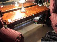 Wood decor sofa table top and overall shape with decorative edges and inlay under lamp lighting.