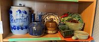 Wide view of shelf with all pottery items showing arrangement and variety of pieces.