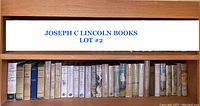 Shelf display of 30 antique books by Joseph C Lincoln labeled as Lot #2