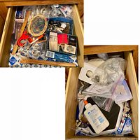 Two drawers each filled with a mixture of office supplies, sewing items, and small hardware tools. Items are loosely packed and include various boxes and plastic bags.