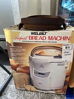 Box of Welbilt Original Bread Machine ABM-100-4 with wood basket on top