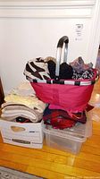 Red tote filled with knit hats and scarves including black, beige, and patterned items, shown from various angles.