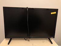 Front view of Vizio 24-inch TV with power cord hanging.