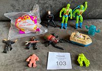 All 11 figures and toys shown together on gray fabric surface