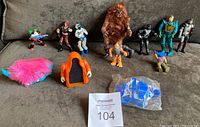 Full lot of 12 action figures and accessories with a variety of sizes and styles photographed on a sofa.