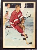 Front view of card showing Gordie Howe in Detroit Red Wings uniform handling puck with printed signature overlay