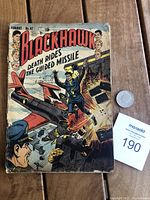 Front cover of Blackhawk No. 67 comic showing action scene with explosions and character in blue uniform.