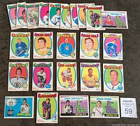 Front view of 24 hockey cards arranged in 4 rows, showing colorful player images and team logos, including Phil Esposito and Brad Park All Star cards.