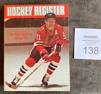 Front cover of 1974-75 Hockey Register featuring Stan Mikita in Chicago Blackhawks uniform, holding a hockey stick on the ice.