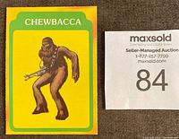 Single Burger King 1977 Star Wars card showing Chewbacca with yellow and green border next to maxsold auction card.