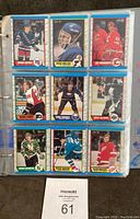 Binder pages containing hockey cards including rookies Joe Sakic, Brian Leetch, and others from the 1989-90 OPC set.