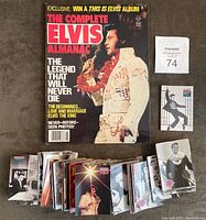 Full view of The Complete Elvis Almanac 1981 magazine and 211 Elvis Presley cards fanned and stacked together.