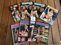 Photo of all 10 Wrestling Fury magazines laid out on a wood floor showing colorful vintage covers including Hulk Hogan and Ted DiBiase.