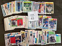 Stacked collection of 171 O-Pee-Chee hockey cards from the 1982-83 and 1983-84 seasons showing various players and teams.