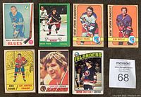 Front view of all seven hockey cards laid out in two rows showing players Bill McCreary, Brad Park (two cards), Jean Ratelle, Henri Richard, Bobby Orr, and Bryan Trottier rookie card.