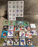 Binder sheet displaying 18 circular 1994 Wayne Gretzky POG discs featuring various images and logos.